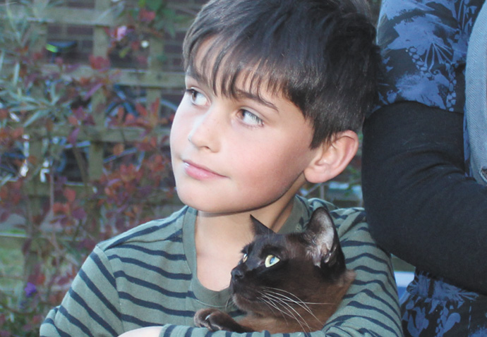 Making a fuss of the puss that was missing from home for a year Jax and Clare Lennard and family