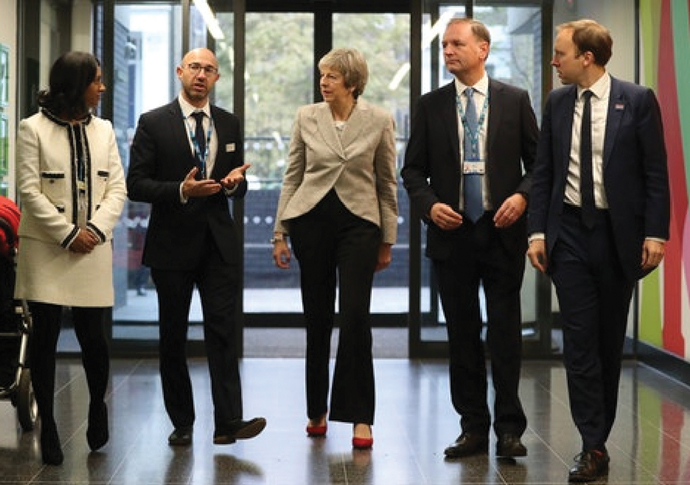 Deep cuts operation threatens NHS Theresa May and health secretary Matt Hancock far right with from left GP partner Dr Jonathan Levy and Simon Stevens