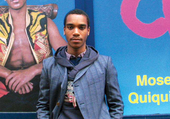 Moses Quiquine next to exhibition hoarding A Cobbinah
