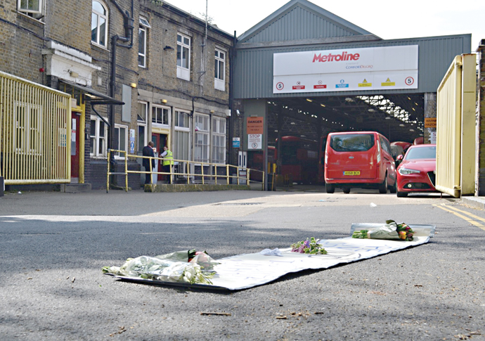 Flowers and banner outside bus depot