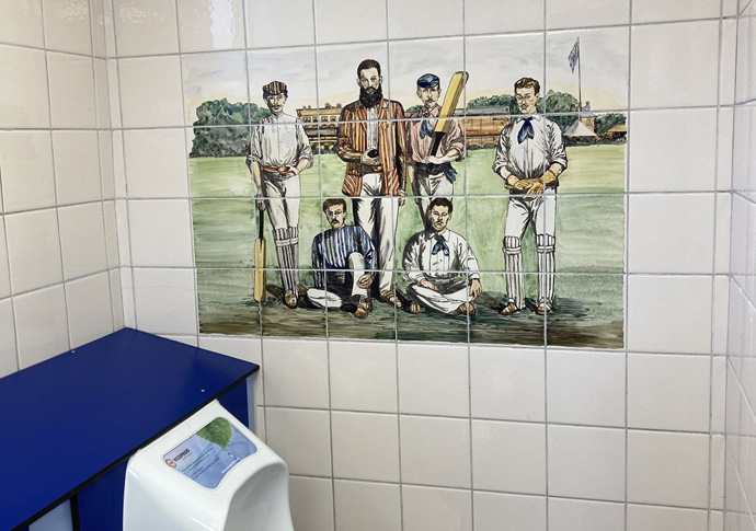 A mural of a cricket team in the male toilet in Wellington Place. Adrian Zorzut